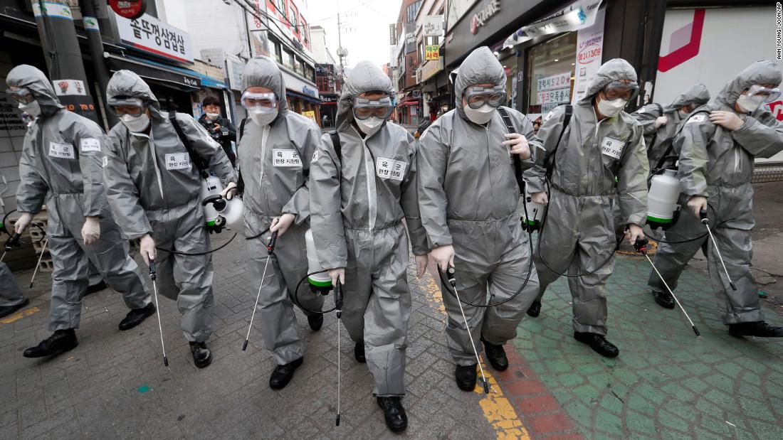 Soldiers spray disinfectant throughout a shopping street in Seoul.